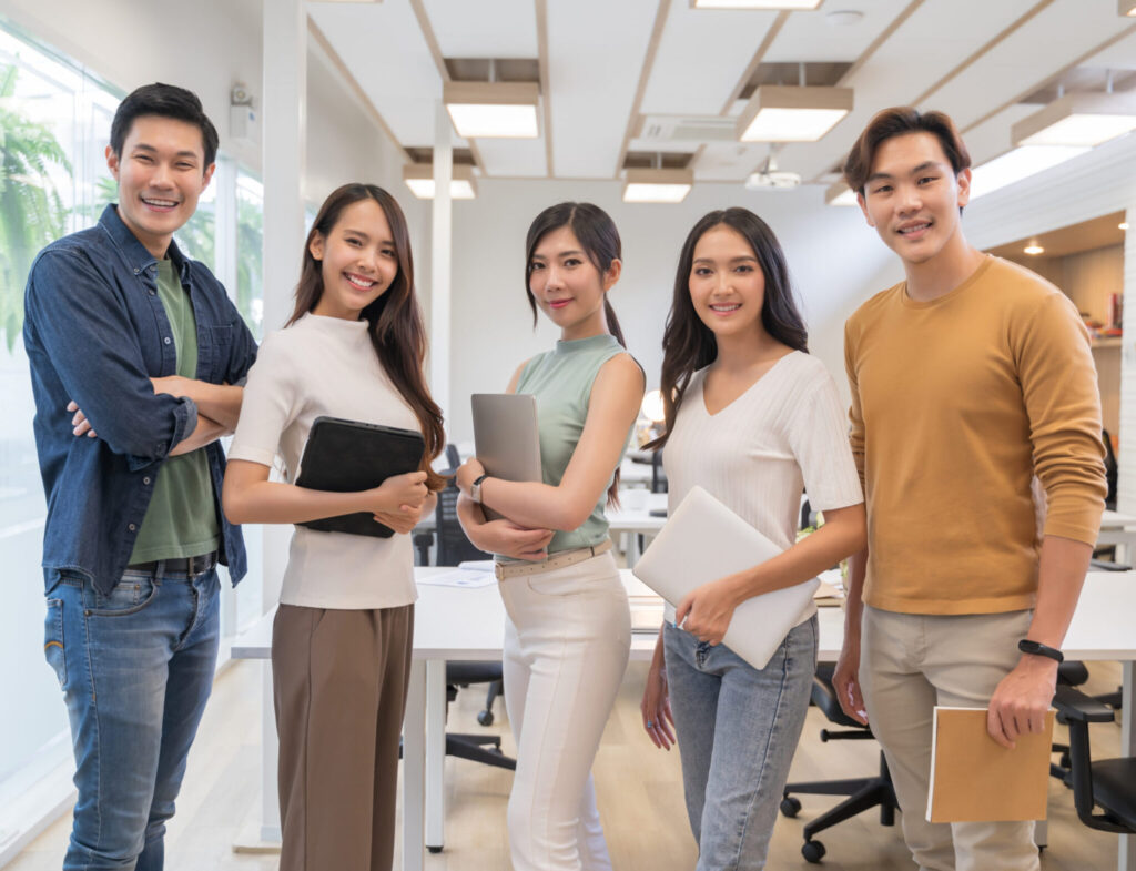 Employees smiling with workplace insurance solutions